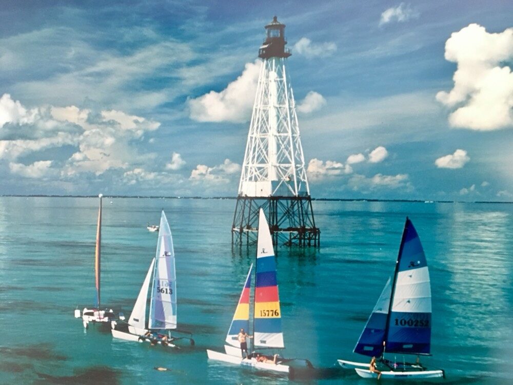 Hobie sailing catamarans gathered beneath the historic Alligator Reef Lighthouse in the Florida Keys