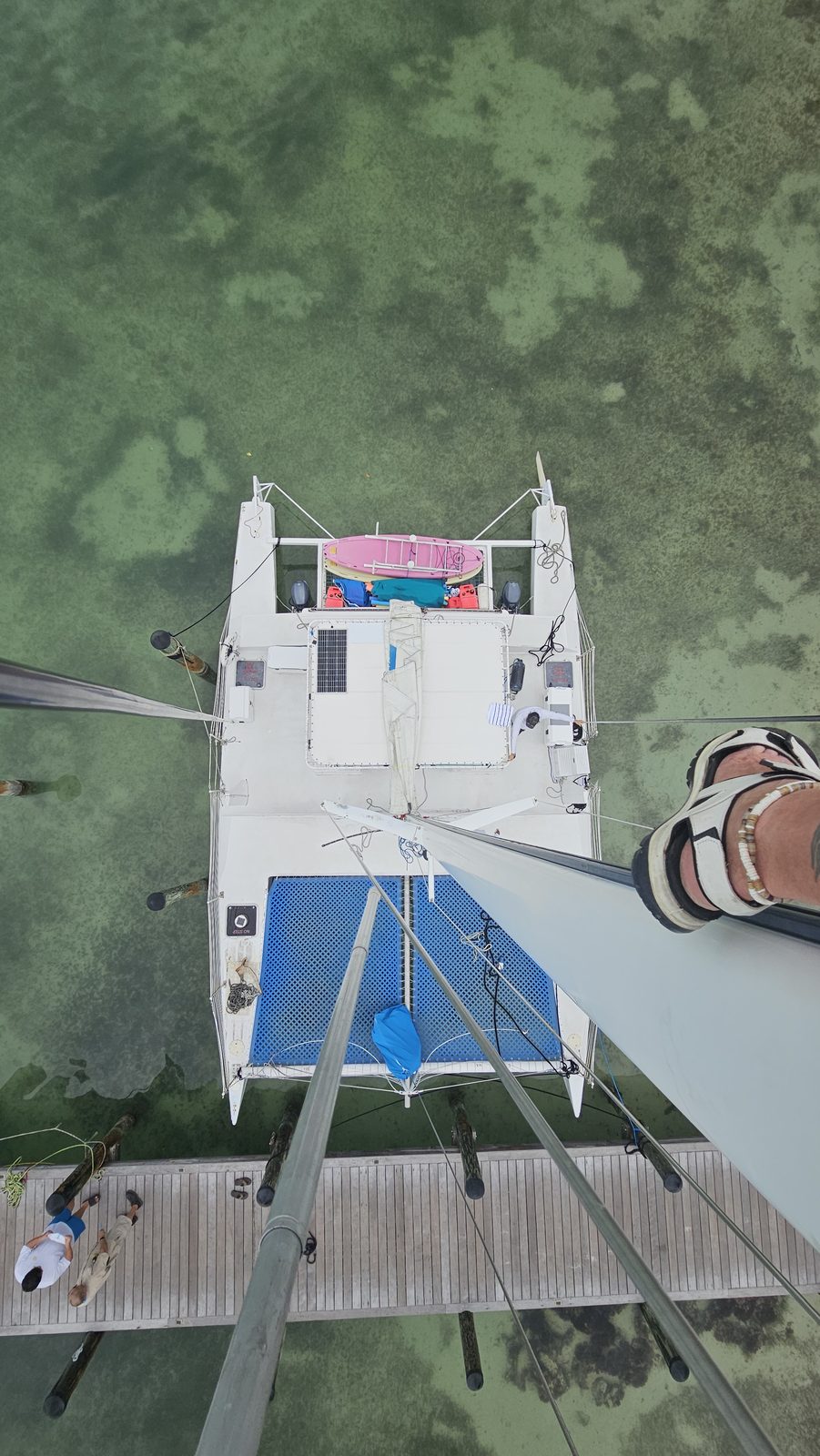 View straight down the mast of the Carolina Moon catamaran to her deck and dock below in Key Largo