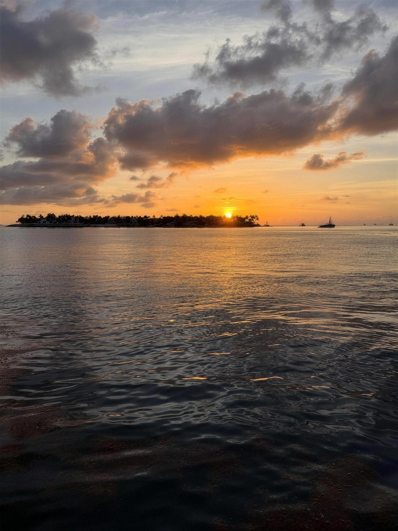 Golden Florida Keys sunset over calm water, ideal for a champagne sunset sailing cruise